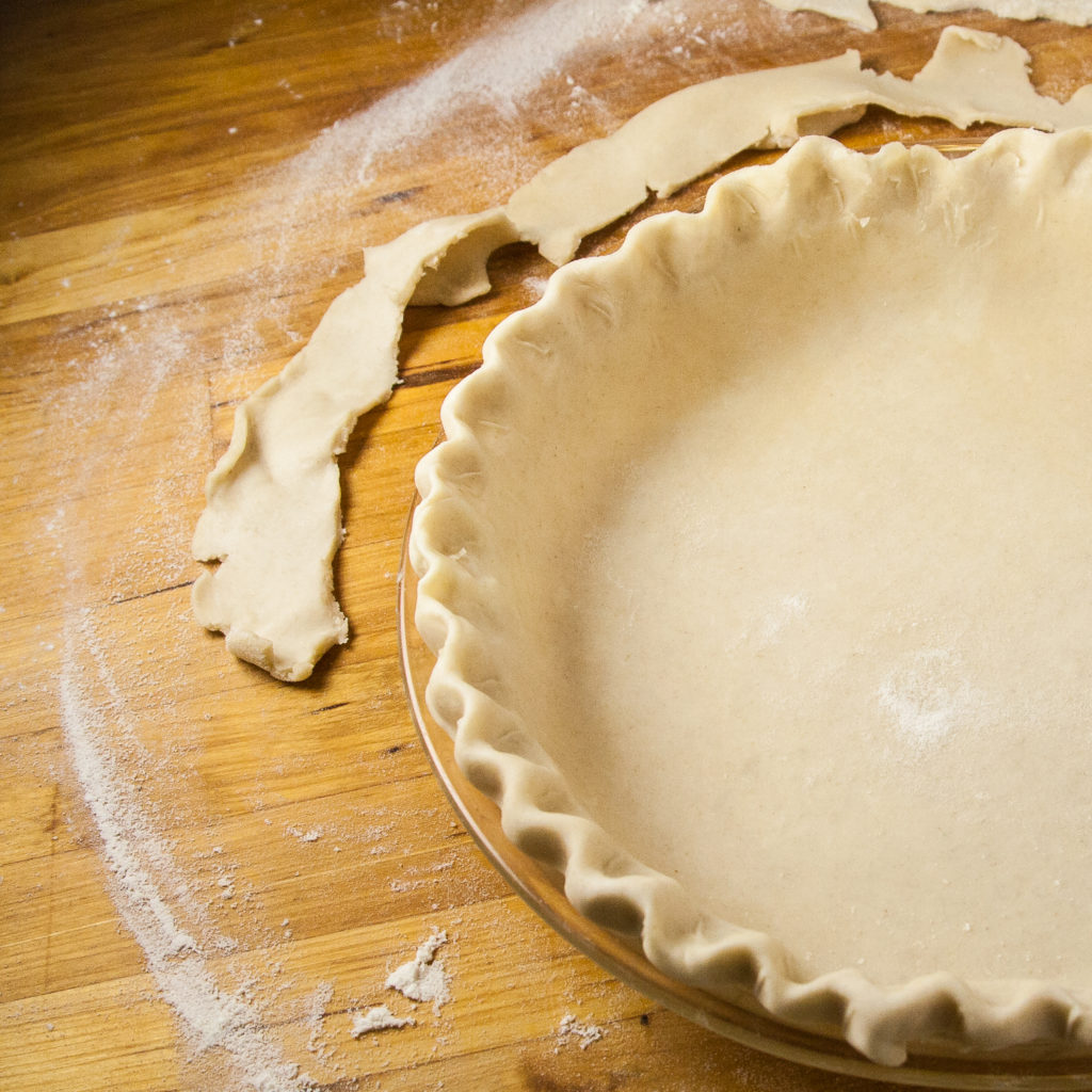 An unbaked pie shell with a simple edge.